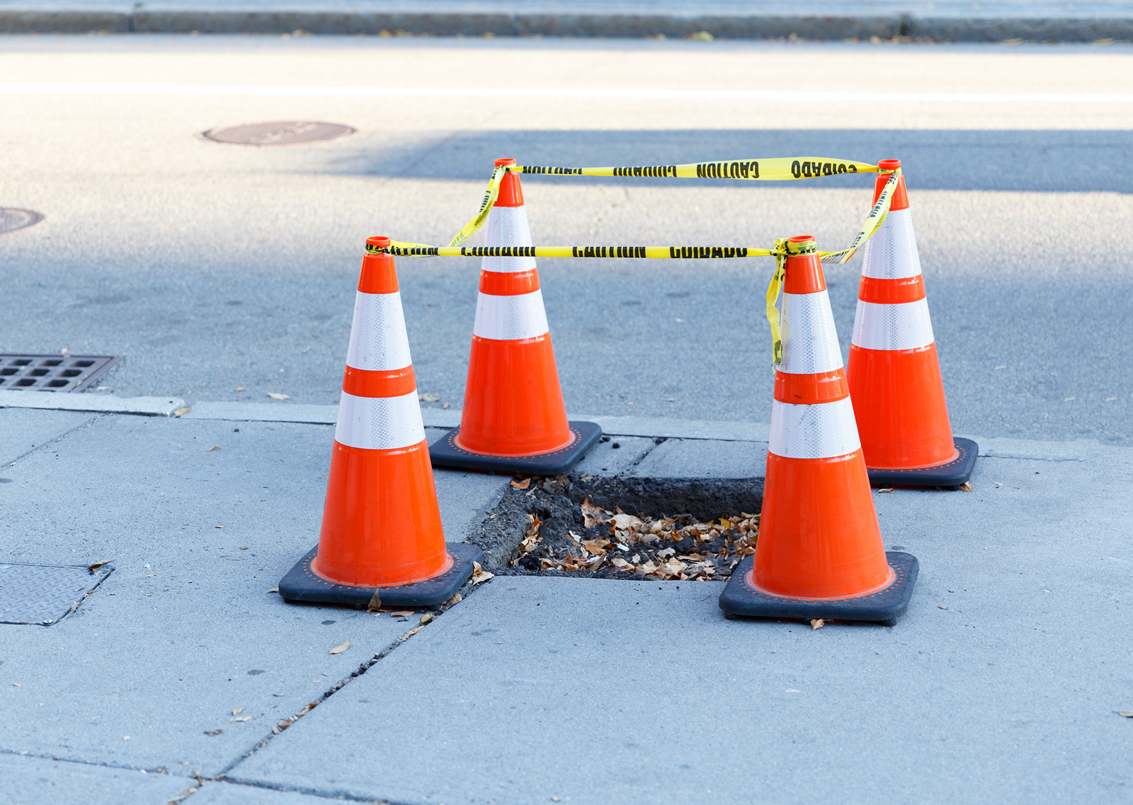 pothole surrounded by cones