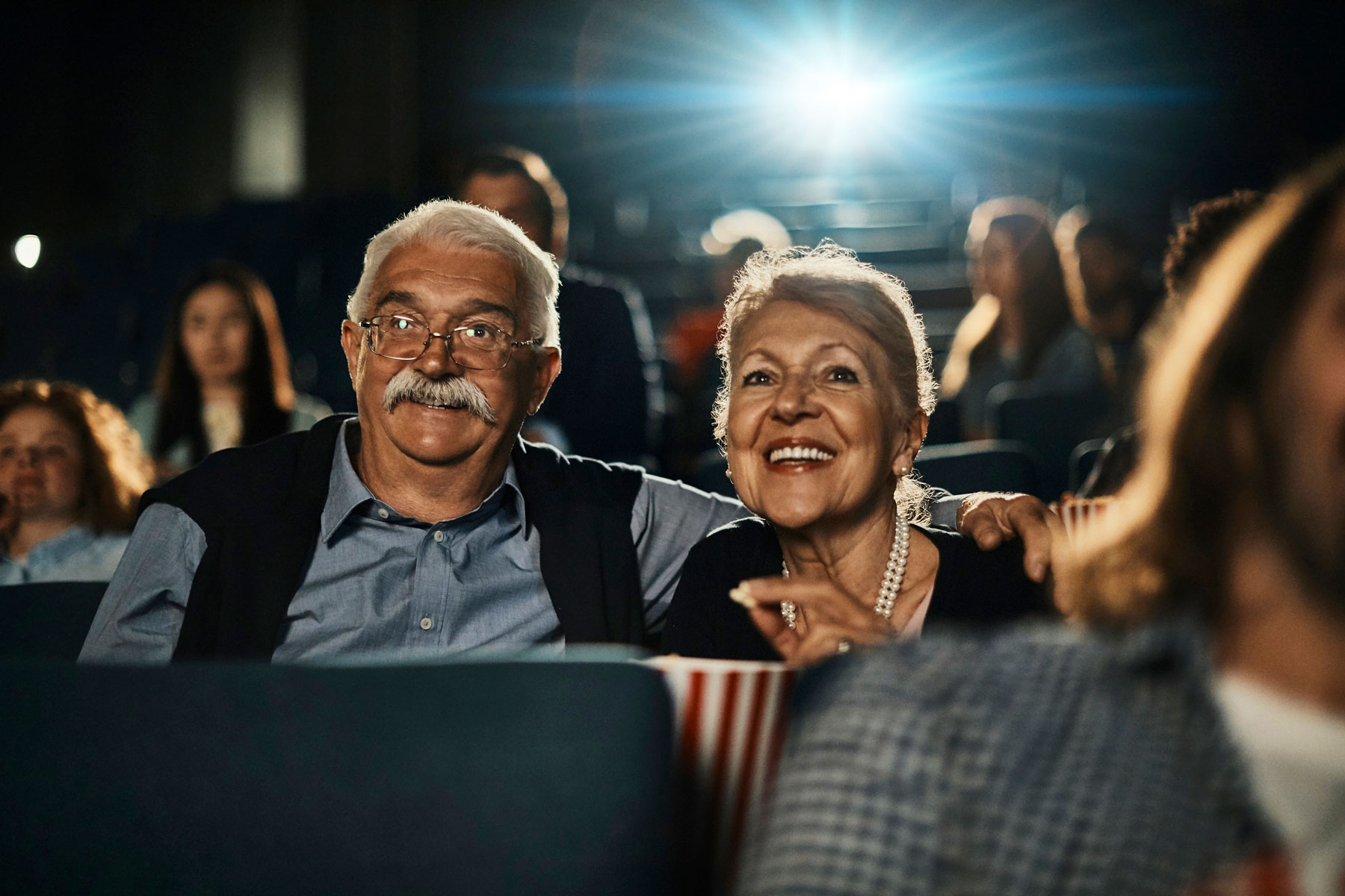 senior couple watching movie inside theatre