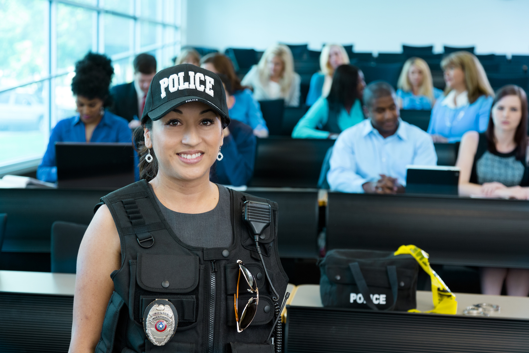 Female police officer in front of classroom