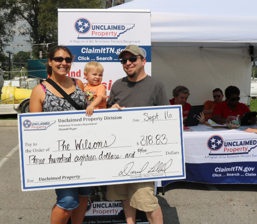family with unclaimed property check at ClaimItTN.gov event