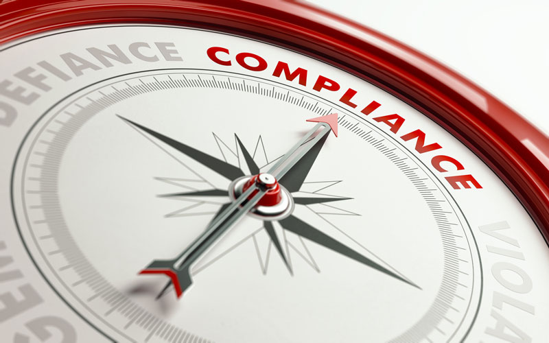 compass with needle pointing toward the word Compliance