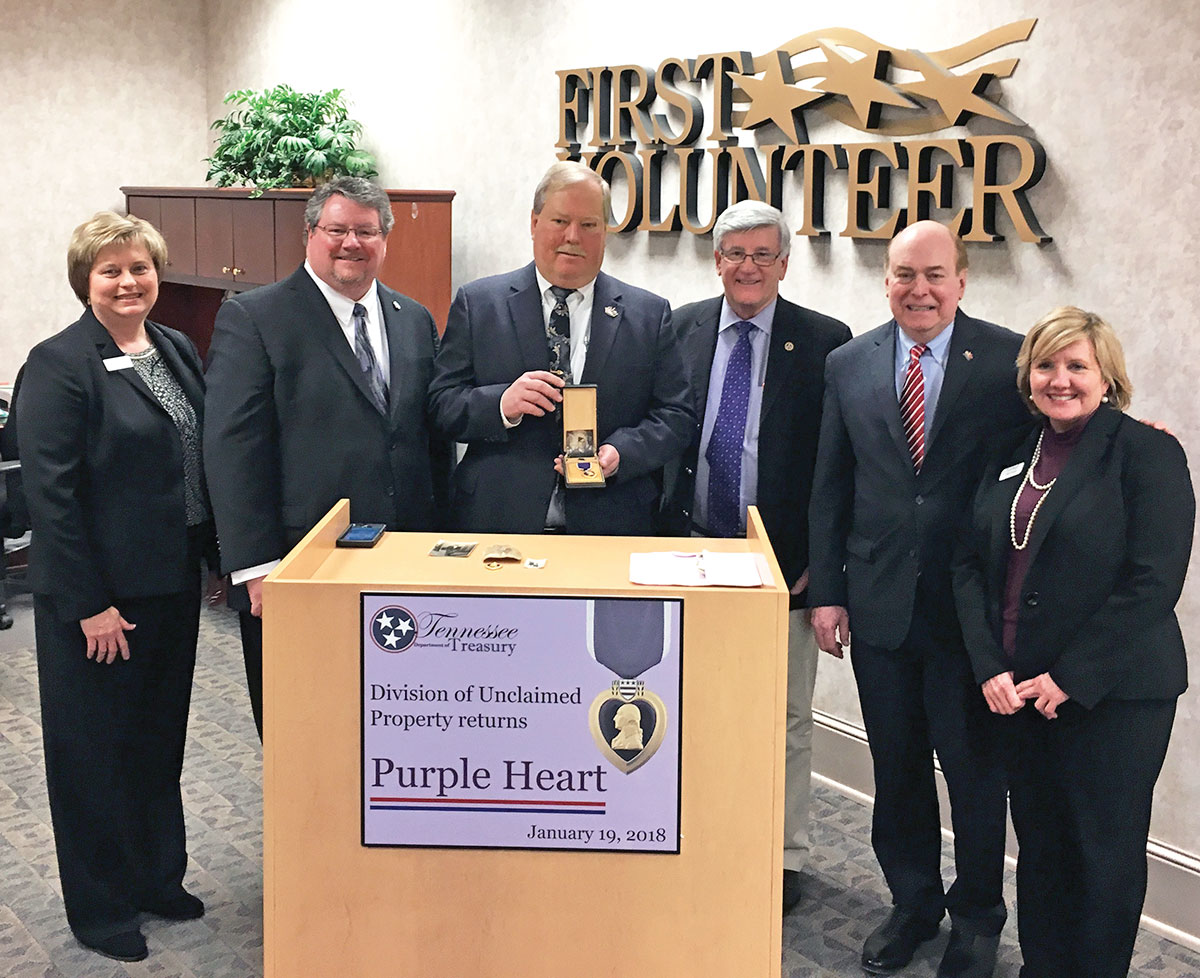 Treasurer Lillard and representatives from the Unclaimed Property team return a Purple Heart to the family of a war hero