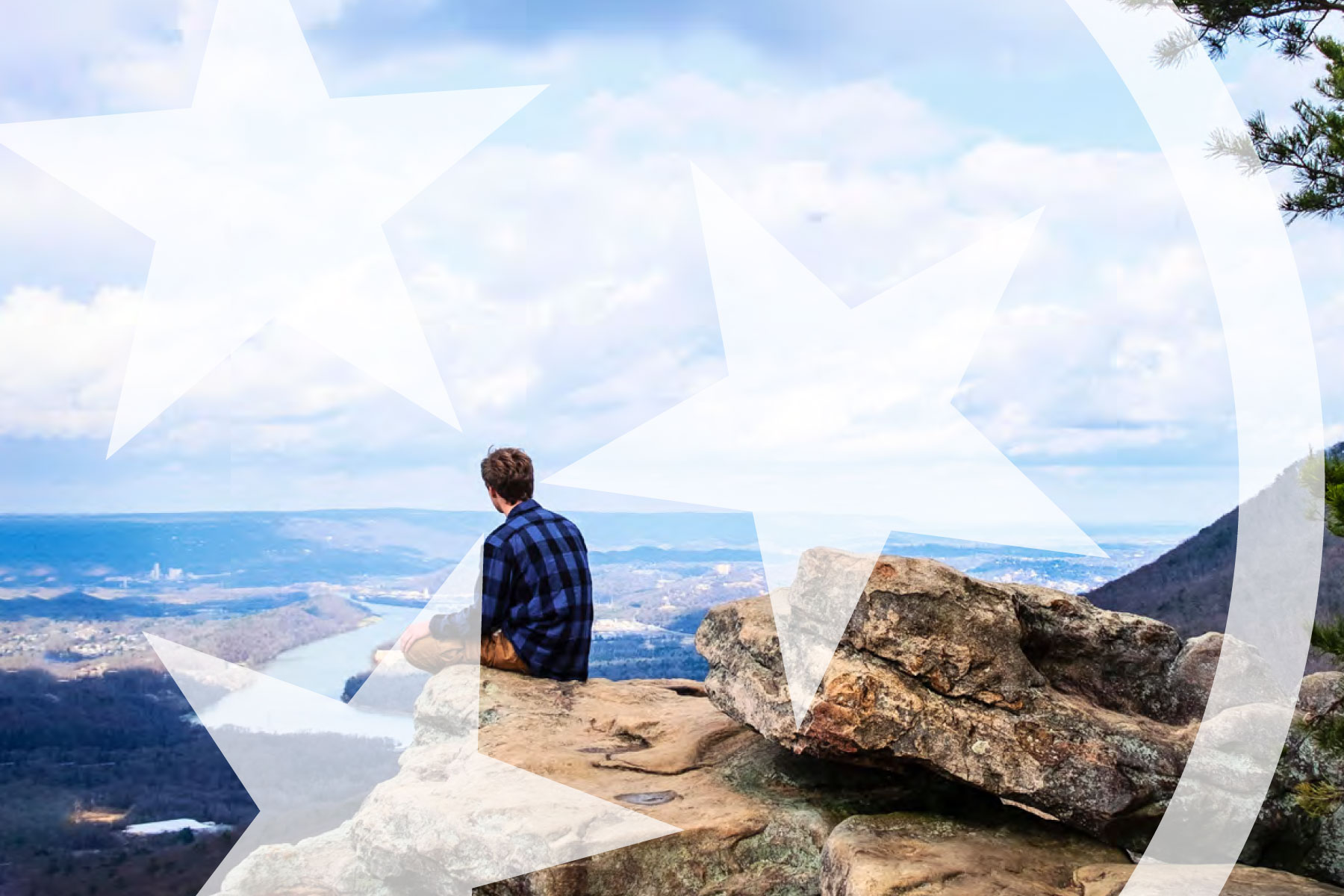 man sitting on Tennessee mountain edge admiring view