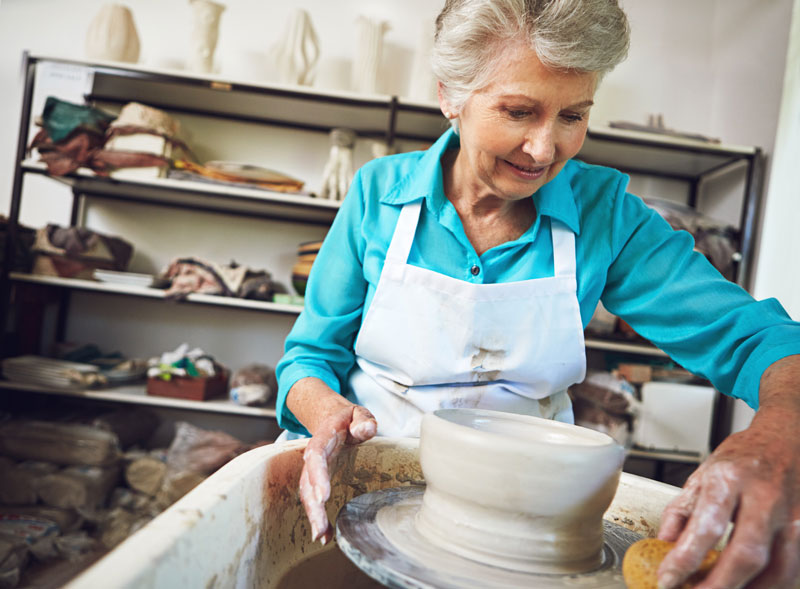 senior female working with pottery