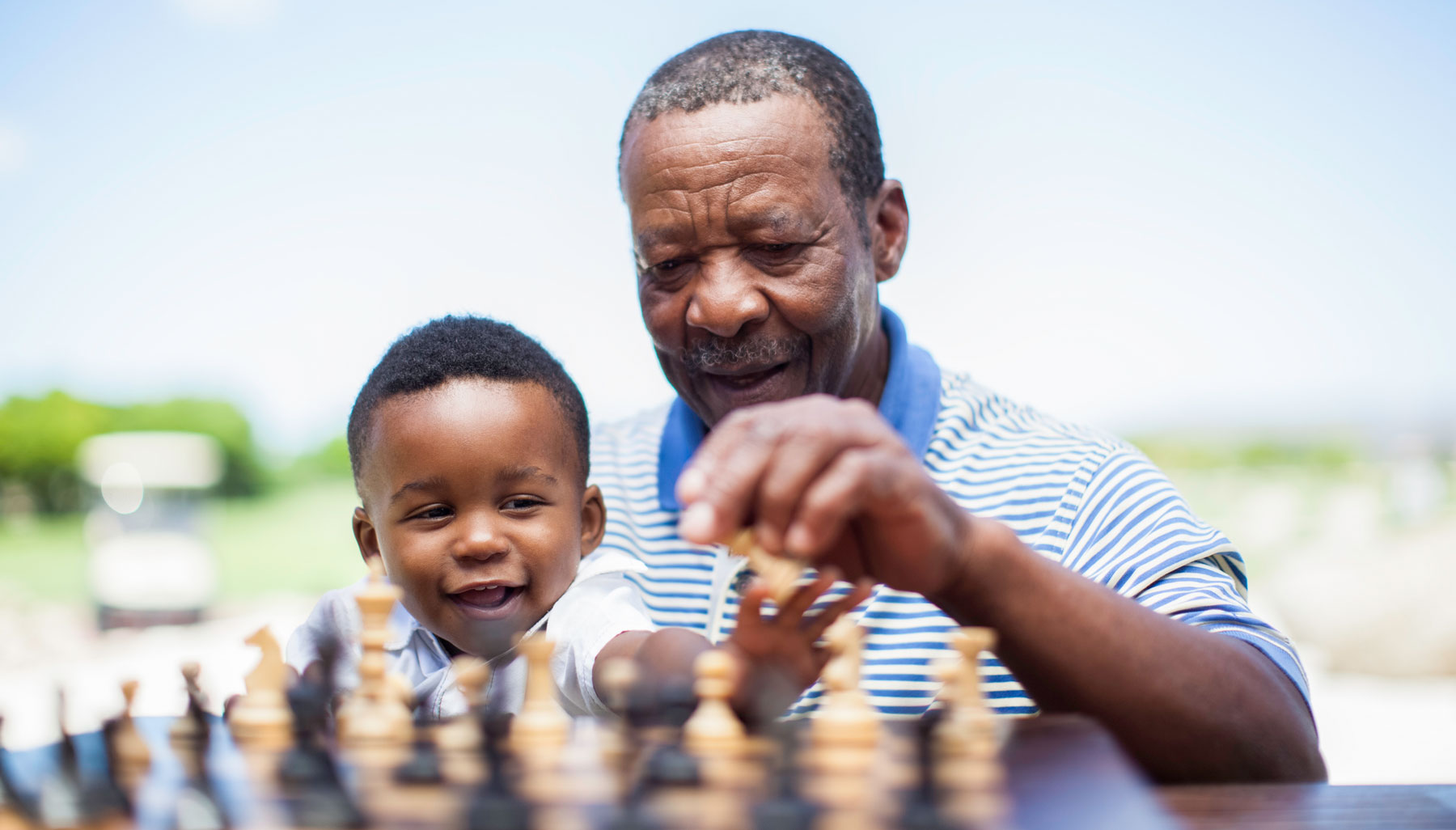 grandfather playing chess with grandson