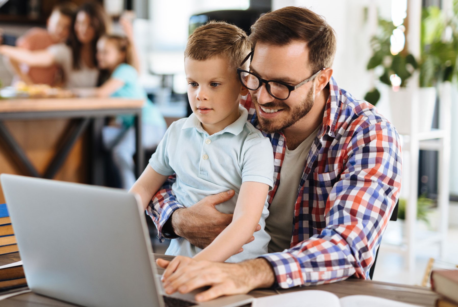 Dad and son at laptop